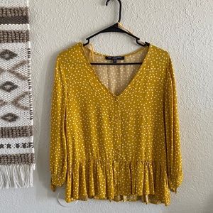 Button up blouse with functional buttons.